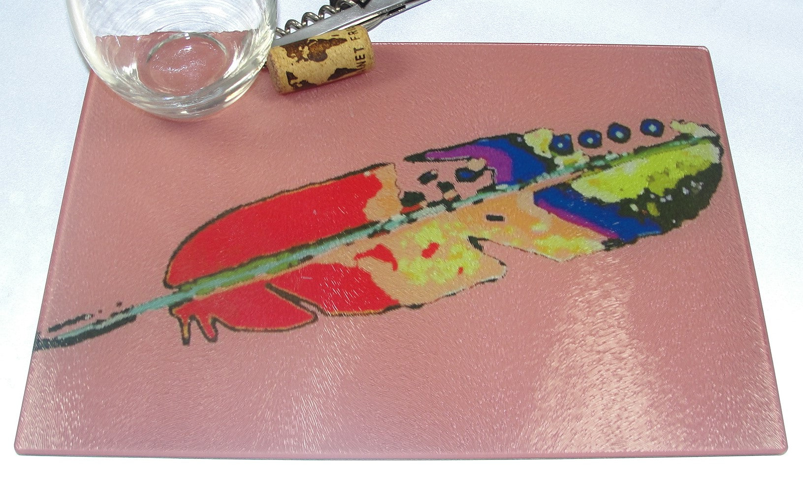 Cutting Board, Glass, Feather on Pink Background