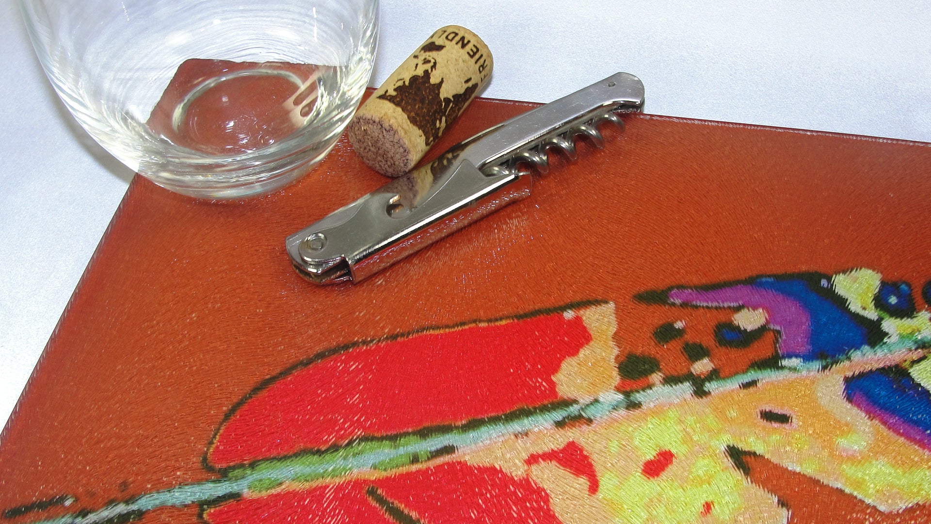 Cutting Board, Glass; Feather on Burnt Siena Background