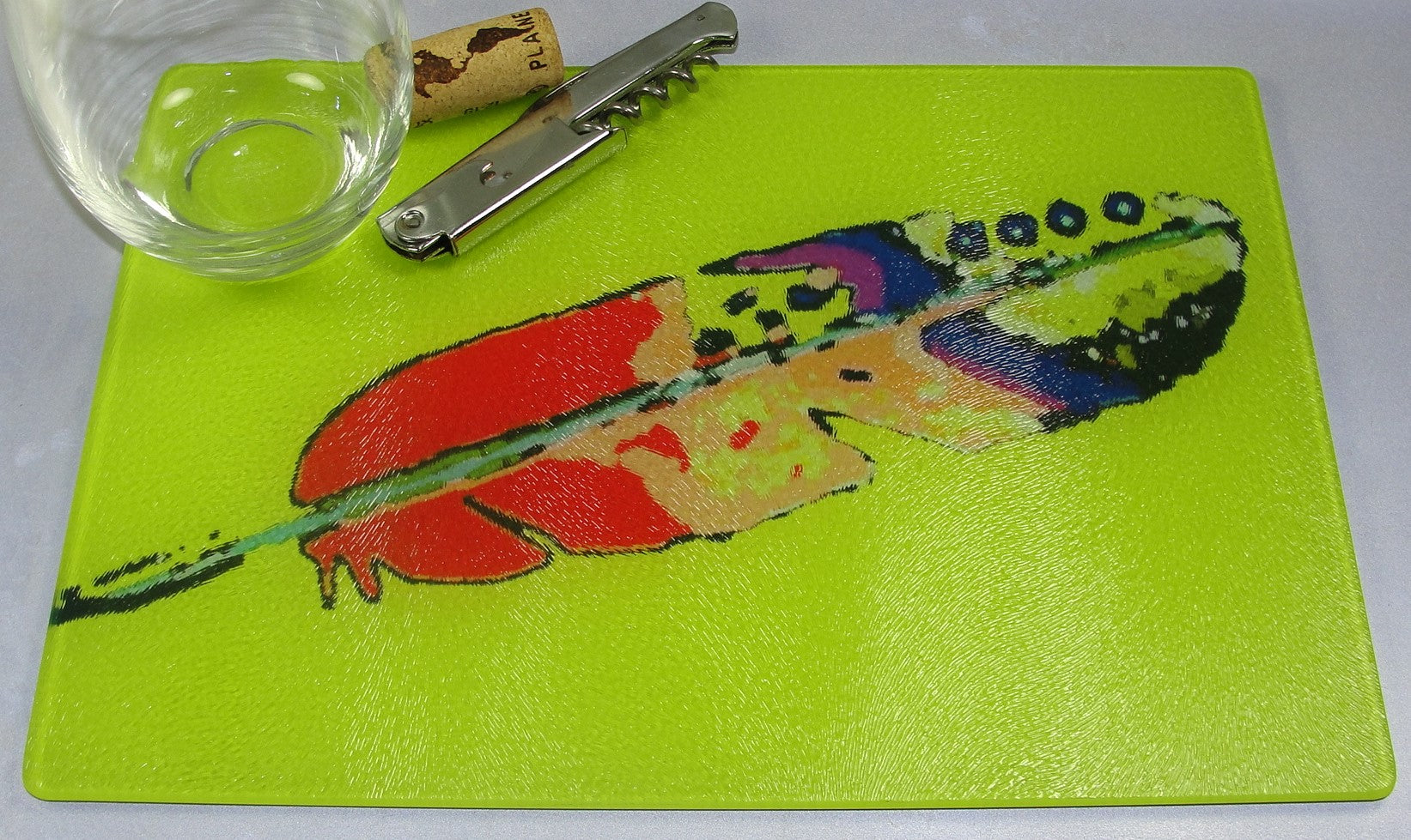 Cutting Board, Glass; Feather on Yellow Background