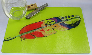 Cutting Board, Glass; Feather on Yellow Background